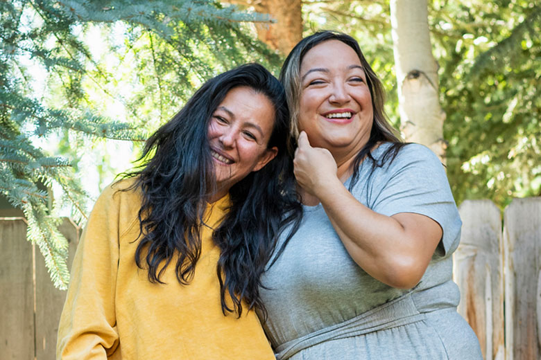 Two women outside smiling